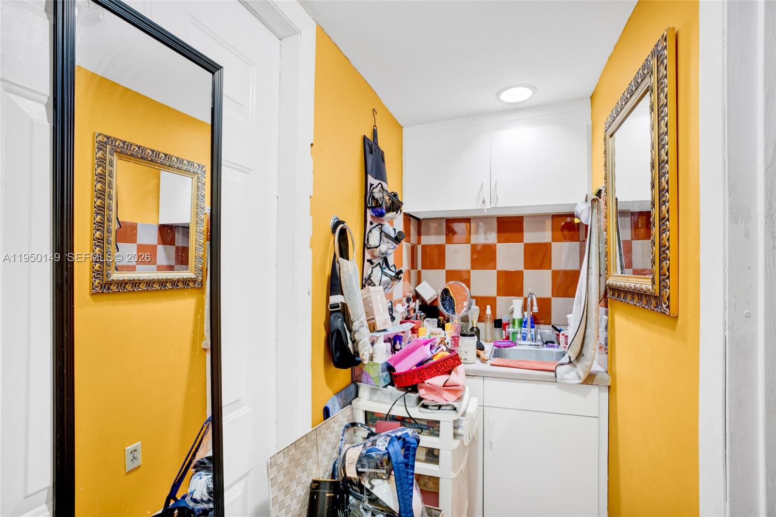 5955 Southwest 4th Street Miami, FL 33144 - Photo 12 of 18 a bathroom with a sink and a mirror