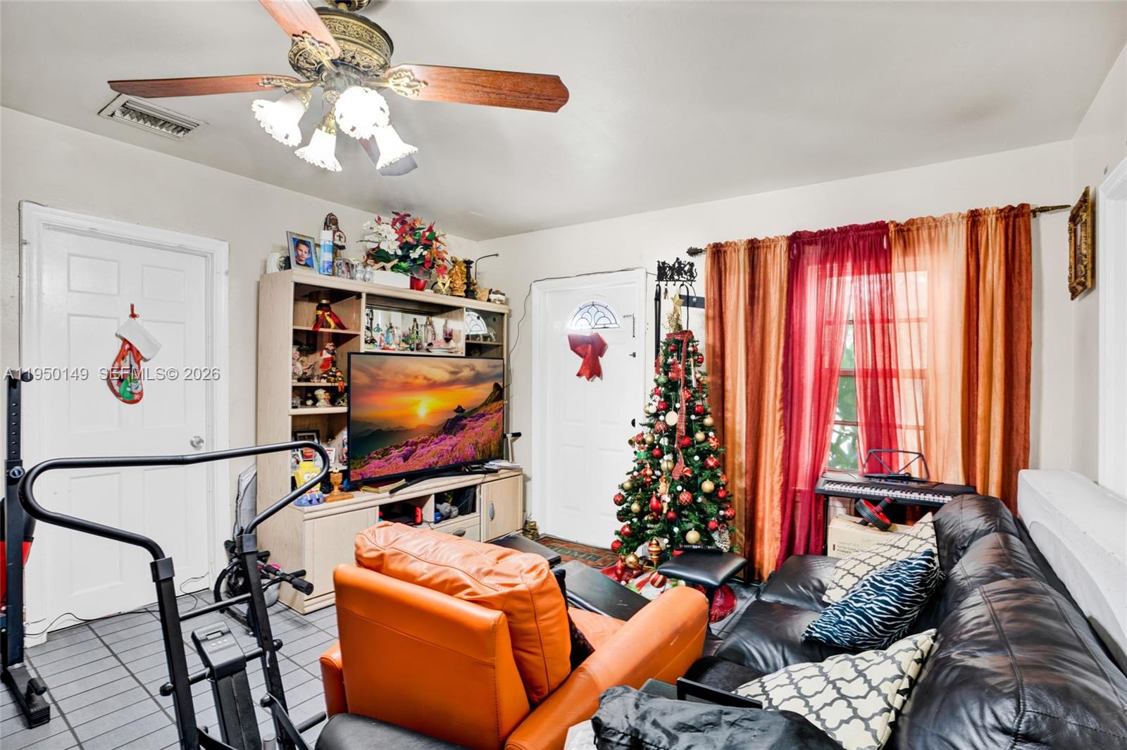 5955 Southwest 4th Street Miami, FL 33144 - Photo 5 of 18 a living room with furniture and a flat screen tv