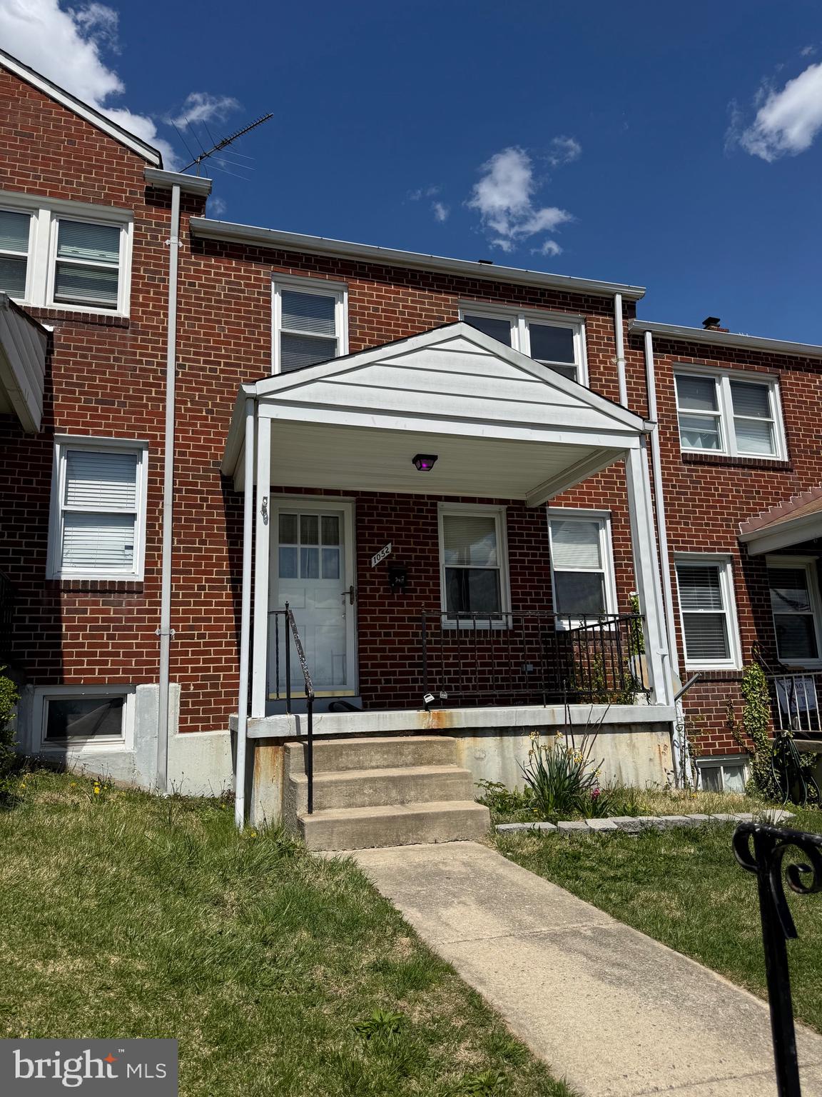 1052 Downton Road Baltimore, MD 21227 - Photo 1 of 55 a front view of a house with a yard
