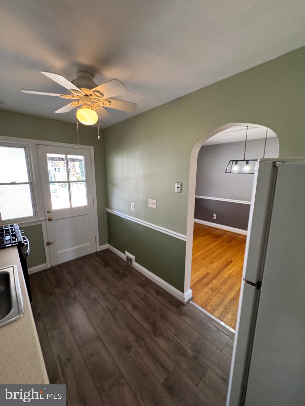 1052 Downton Road Baltimore, MD 21227 - Photo 13 of 55 a view of empty room with window and wooden floor
