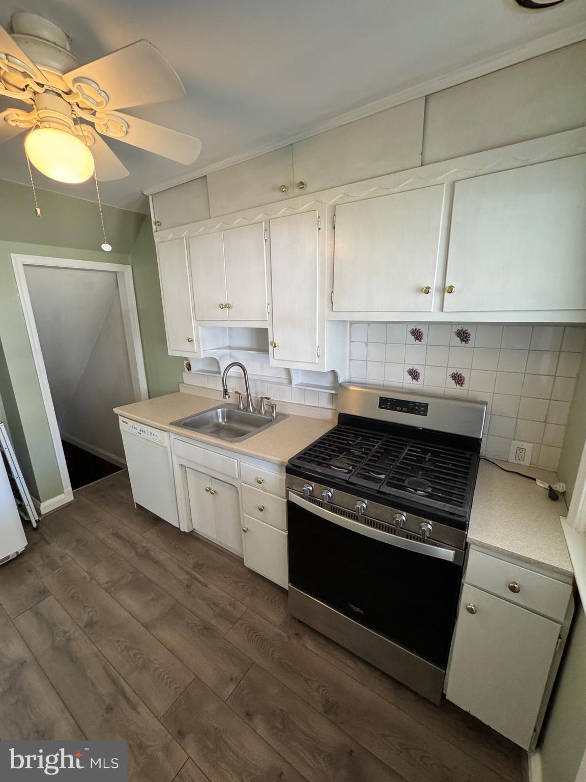 1052 Downton Road Baltimore, MD 21227 - Photo 14 of 55 a kitchen with a sink stove and cabinets
