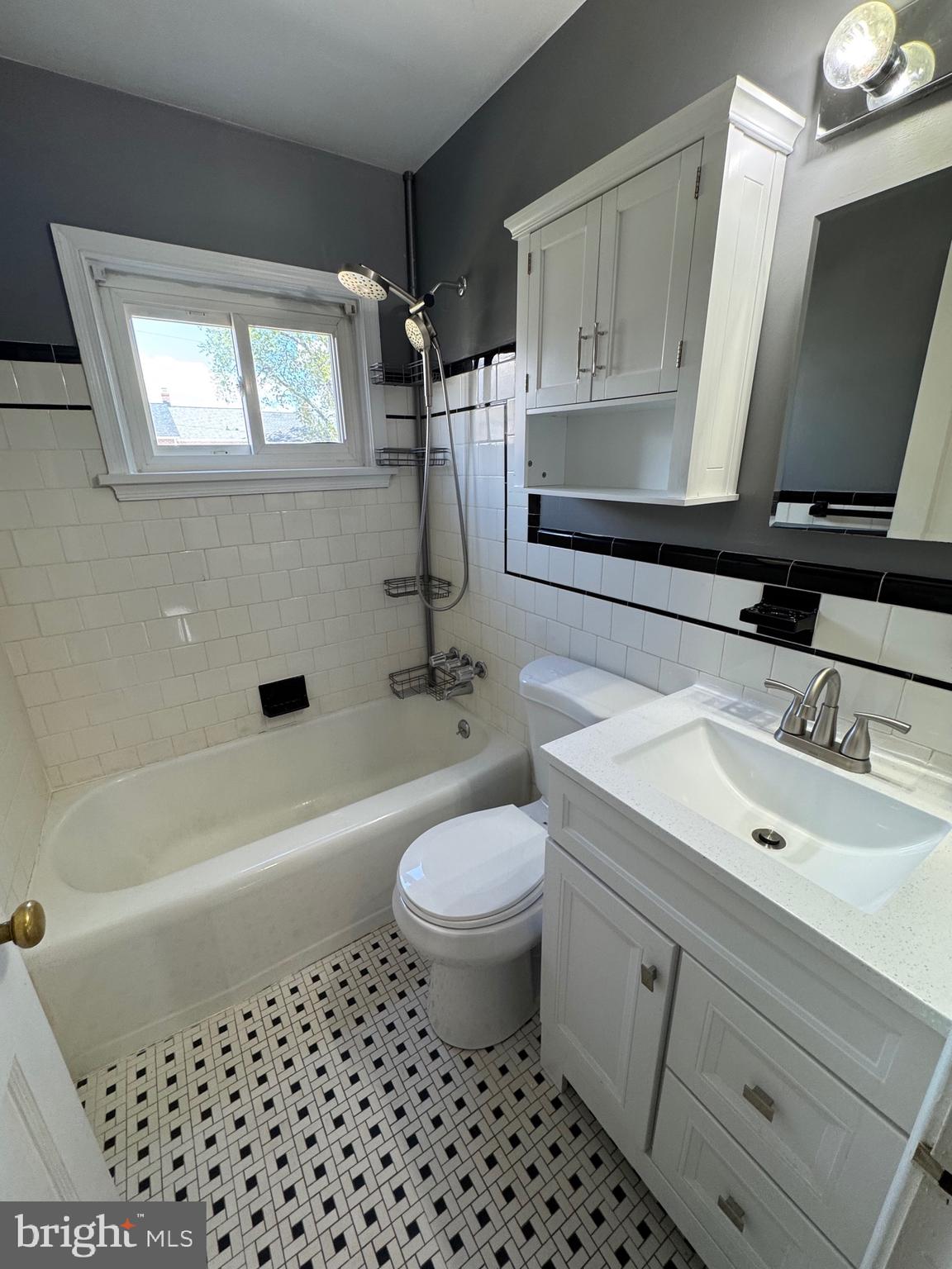 1052 Downton Road Baltimore, MD 21227 - Photo 19 of 55 a bathroom with a sink a toilet and bathtub