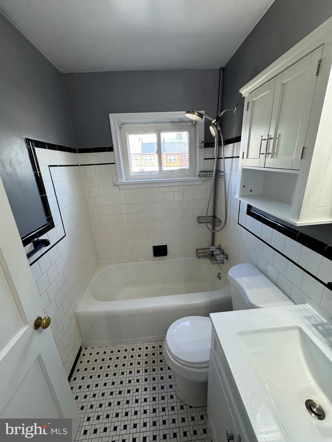 1052 Downton Road Baltimore, MD 21227 - Photo 20 of 55 a bathroom with a sink a toilet and shower