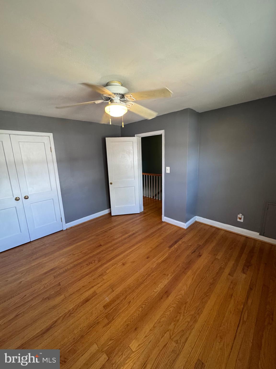 1052 Downton Road Baltimore, MD 21227 - Photo 23 of 55 a view of empty room with wooden floor and fan