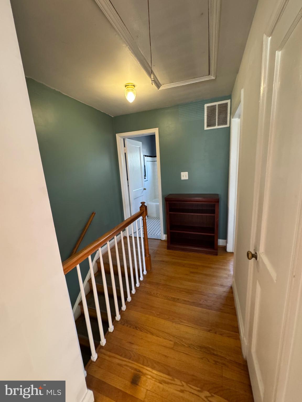 1052 Downton Road Baltimore, MD 21227 - Photo 28 of 55 a view of a hallway with wooden floor and staircase