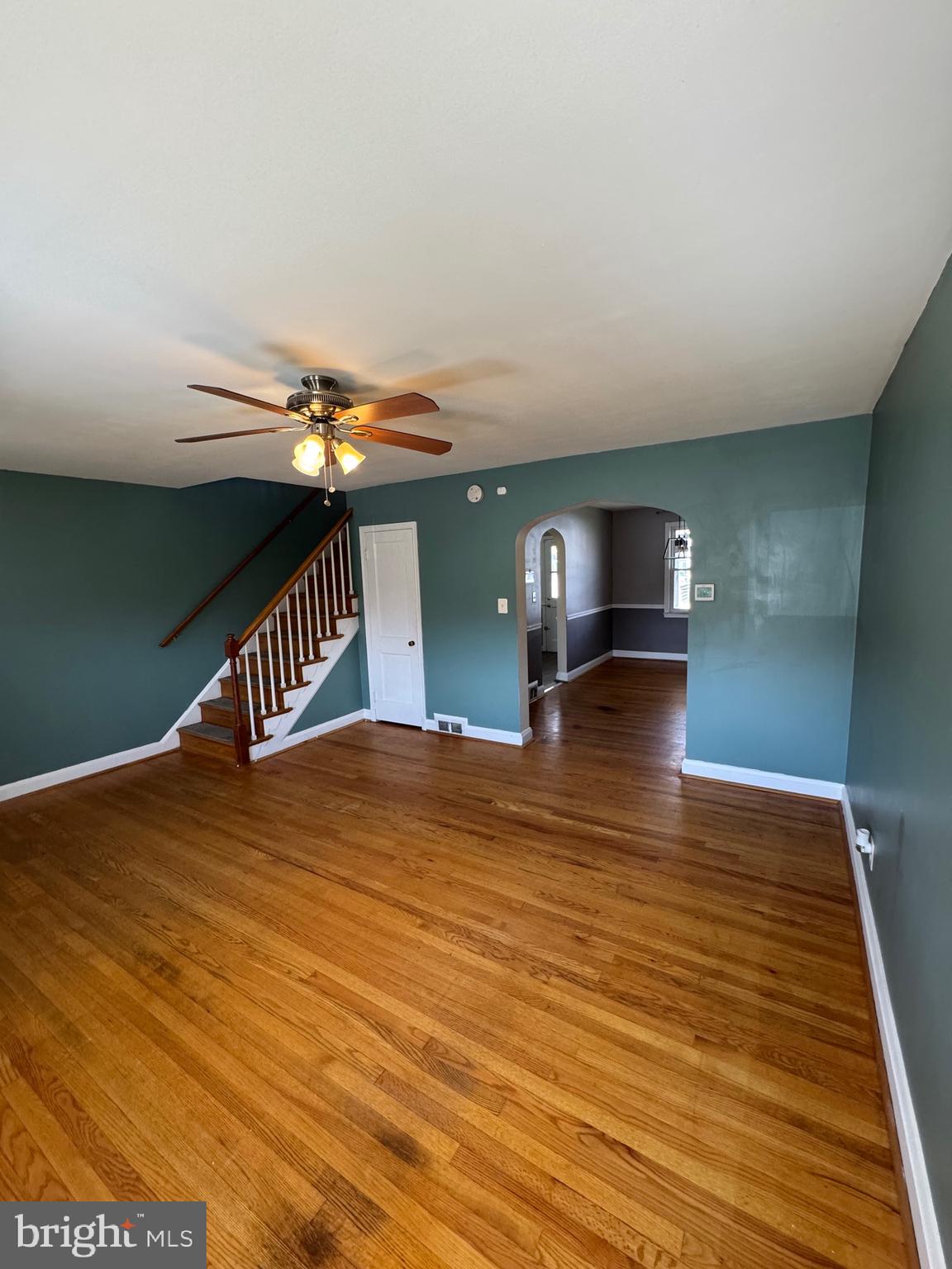 1052 Downton Road Baltimore, MD 21227 - Photo 4 of 55 a bedroom with a bed and wooden floor