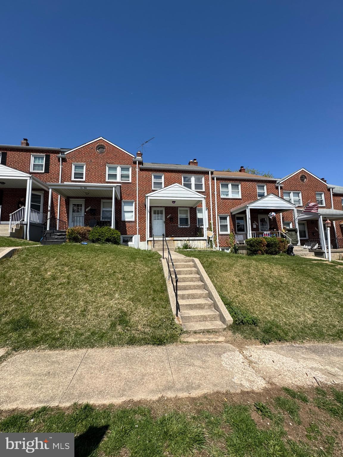 1052 Downton Road Baltimore, MD 21227 - Photo 50 of 55 a front view of a building with a yard