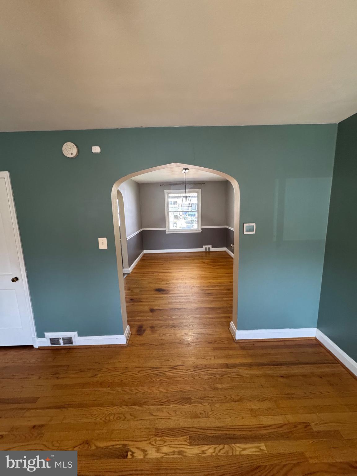 1052 Downton Road Baltimore, MD 21227 - Photo 6 of 55 a view of empty room with wooden floor