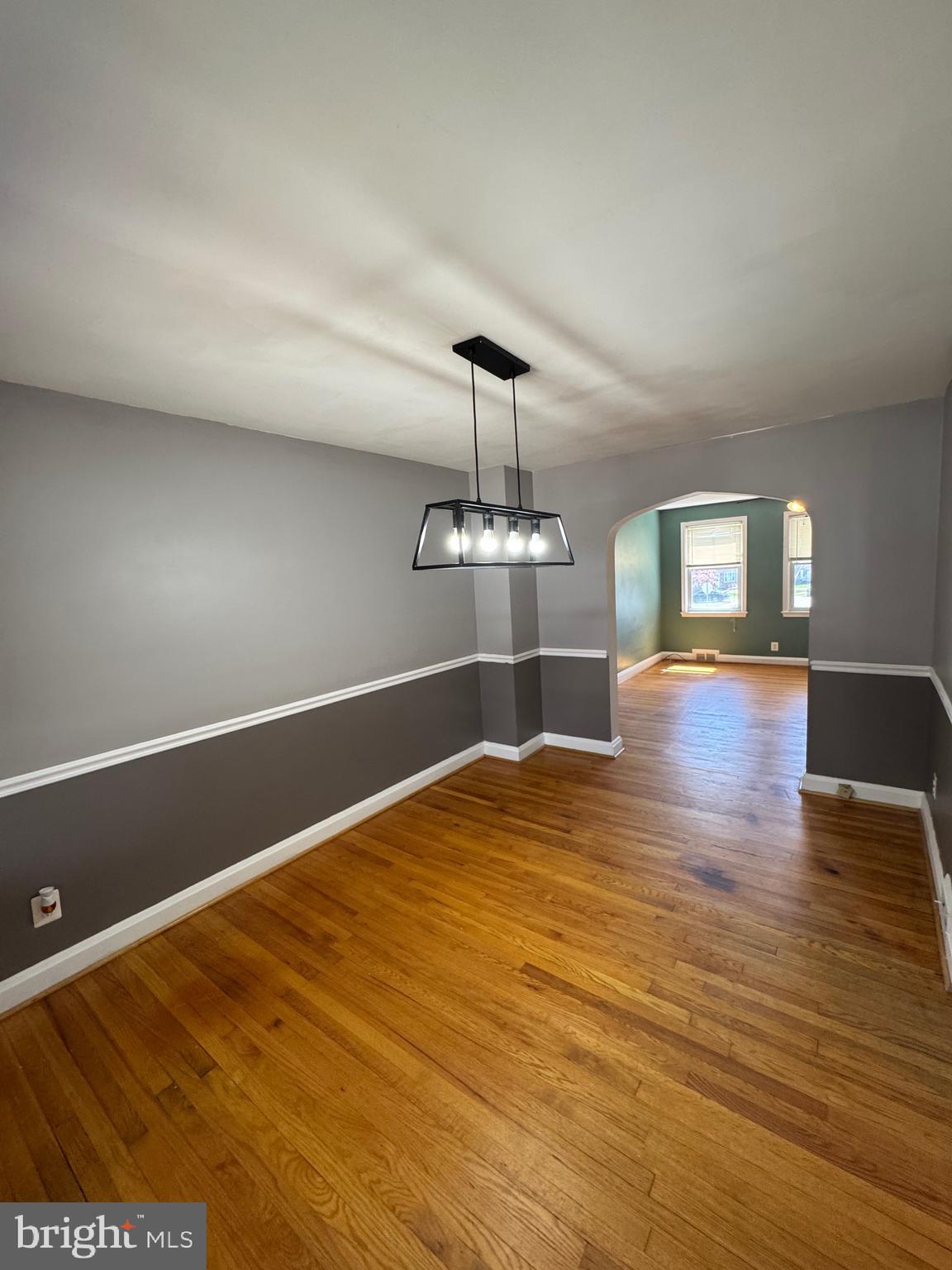 1052 Downton Road Baltimore, MD 21227 - Photo 10 of 55 a view of a room with wooden floor chandelier and a window