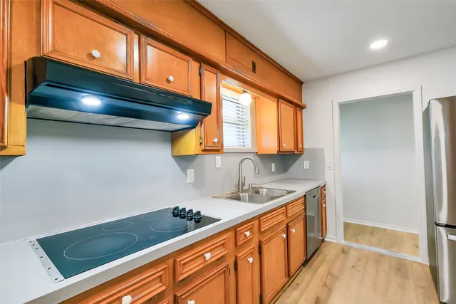 a kitchen with stainless steel appliances granite countertop a sink stove and cabinets