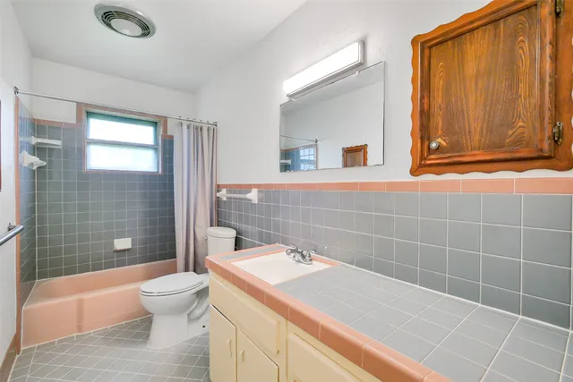 a view of a big room with wooden floor and ceiling fan