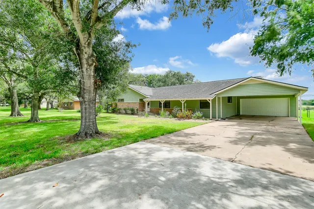 a front view of a house with a garden and yard