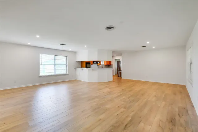 a view of an empty room and a window