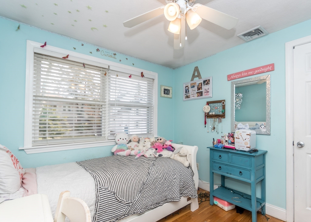 27 Sherman Street Needham, MA 02494 - Photo 16 of 32 a bedroom with a bed and a chandelier