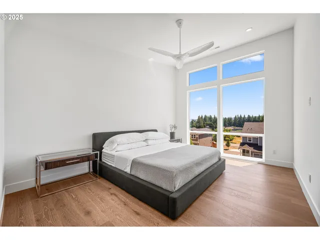 a living room with a bed furniture and a large window