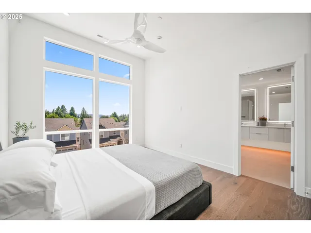 a bedroom with a bed and a view of kitchen