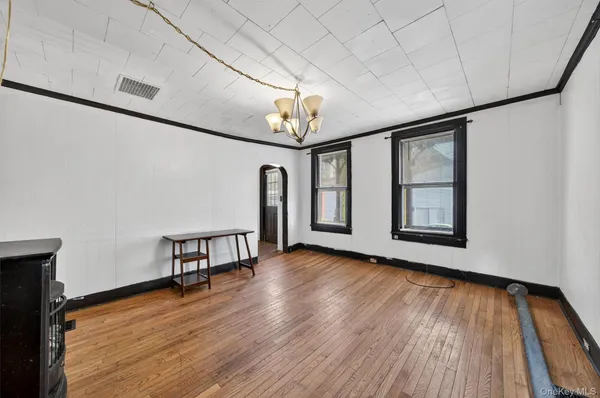 a view of room with window and wooden floor