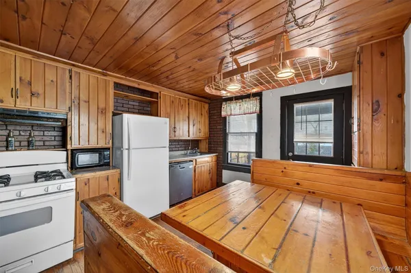 a kitchen with a refrigerator and a stove