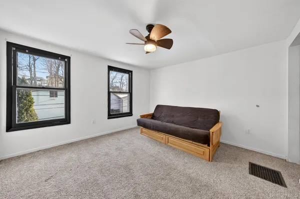a bedroom with a bed and a chandelier fan