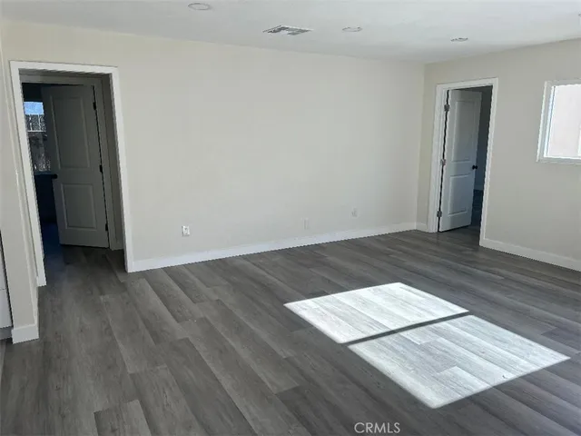 an empty room with wooden floor