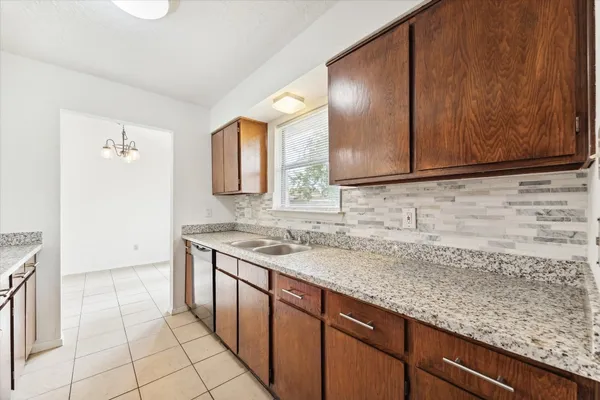 a kitchen with stainless steel appliances granite countertop a stove sink and cabinets