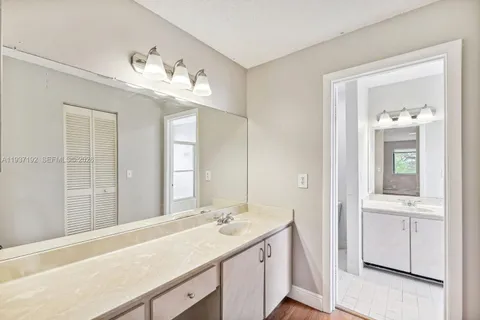 a bathroom with a sink vanity and a mirror