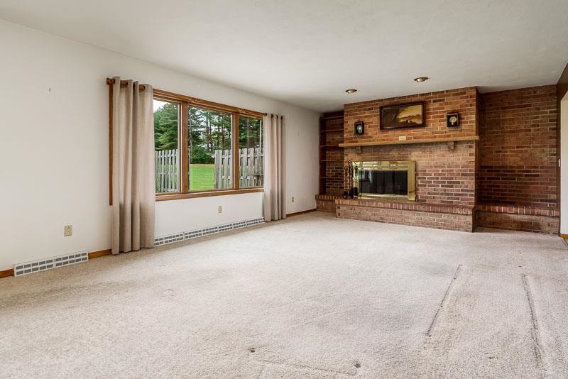 2369 South Lowden Road Oregon, IL 61061 - Photo 16 of 51 a view of an empty room with a fireplace and a window