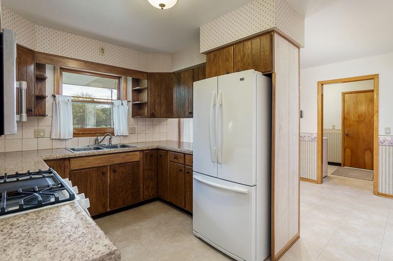 2369 South Lowden Road Oregon, IL 61061 - Photo 20 of 51 a kitchen with a refrigerator and a sink