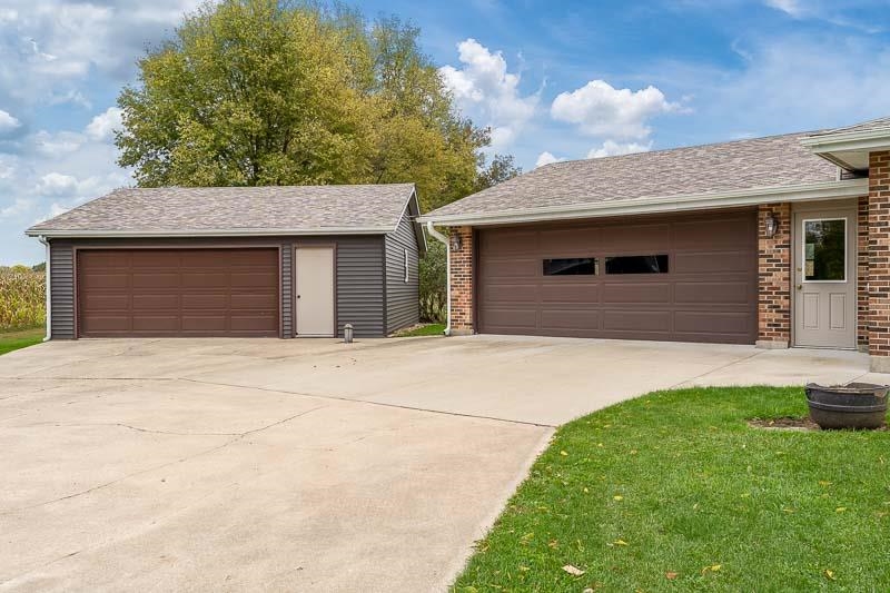 2369 South Lowden Road Oregon, IL 61061 - Photo 6 of 51 a front view of a house with a yard and garage