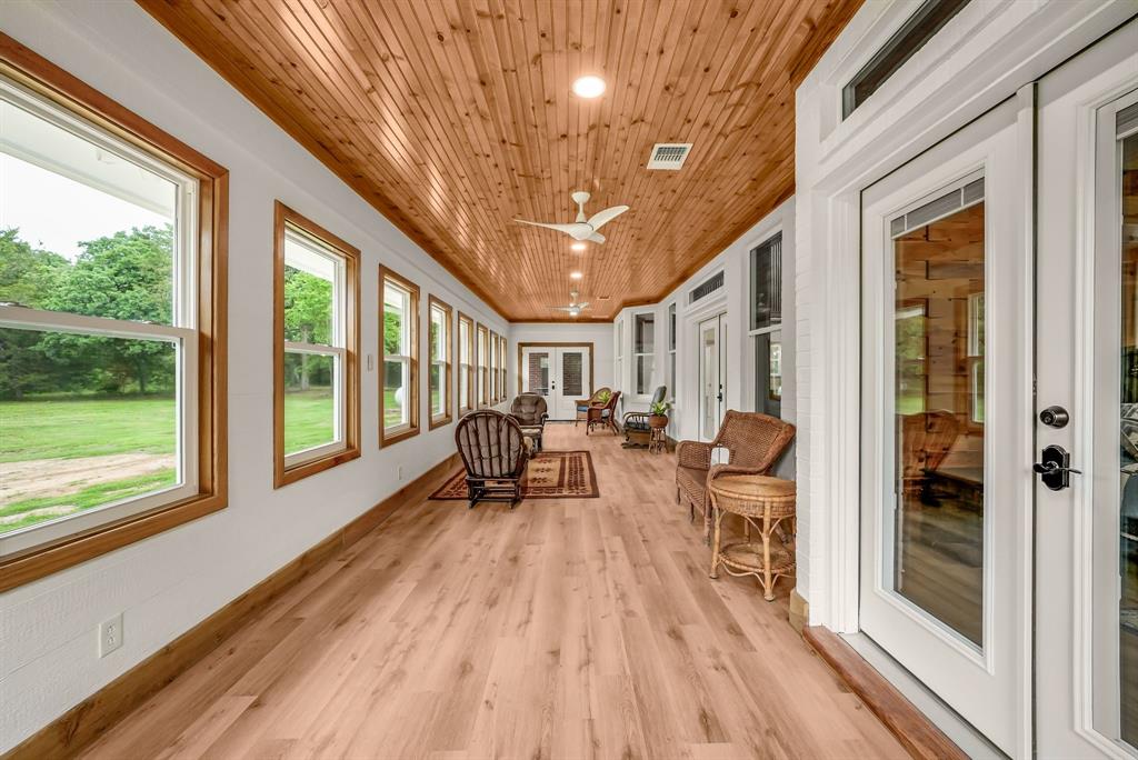 1037 Harrison Road Denison, TX 75021 - Photo 18 of 39 Spacious sunroom featuring extensive wood-finish flooring and a natural wood plank ceiling