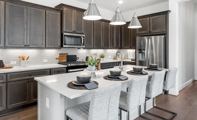 a kitchen with appliances cabinets and a sink