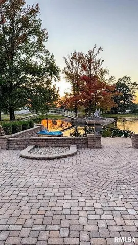 a view of swimming pool with outdoor seating and yard in the back