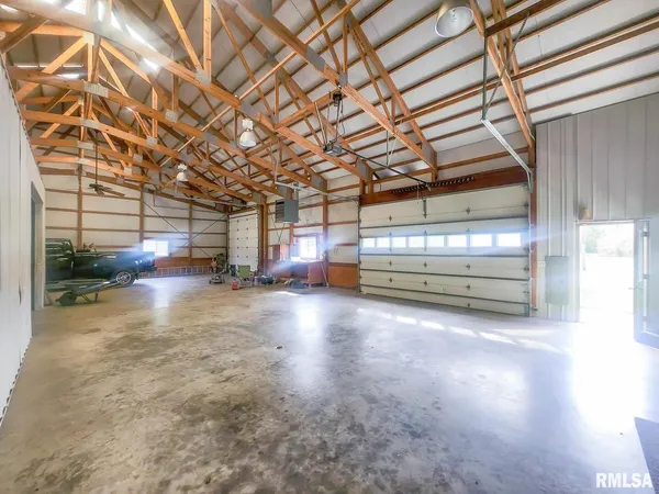 a living room with furniture gym equipment and a large window