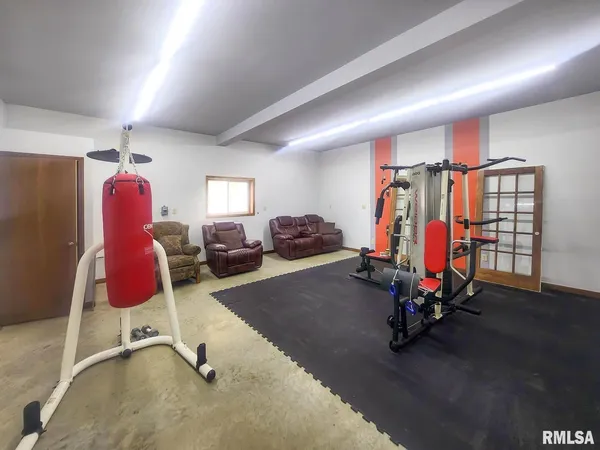 a room with lots of furniture and wooden floors