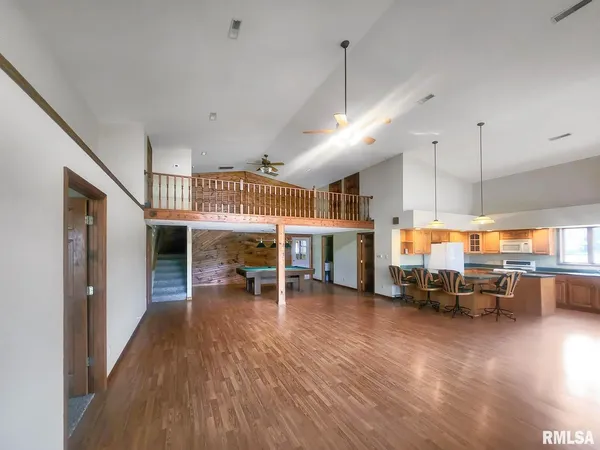 a room with pool table and wooden floor