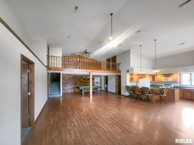 a dining room with furniture and wooden floor