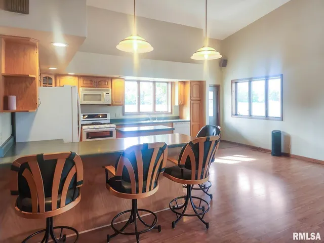 a bathroom with a sink a toilet a mirror and shower