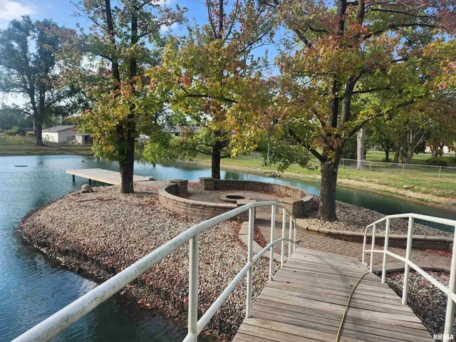 a view of a deck with chairs and trees