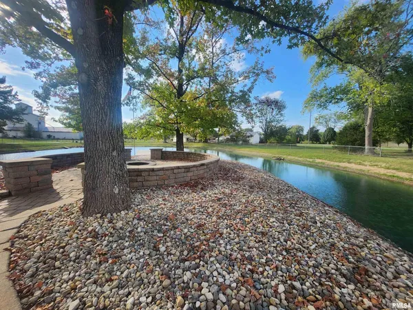 a view of a yard with large trees