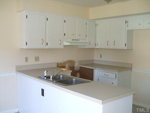 1304 Seaton Road, Unit 31 Durham, NC 27713 - Photo 3 of 10 a kitchen with granite countertop white cabinets and a sink