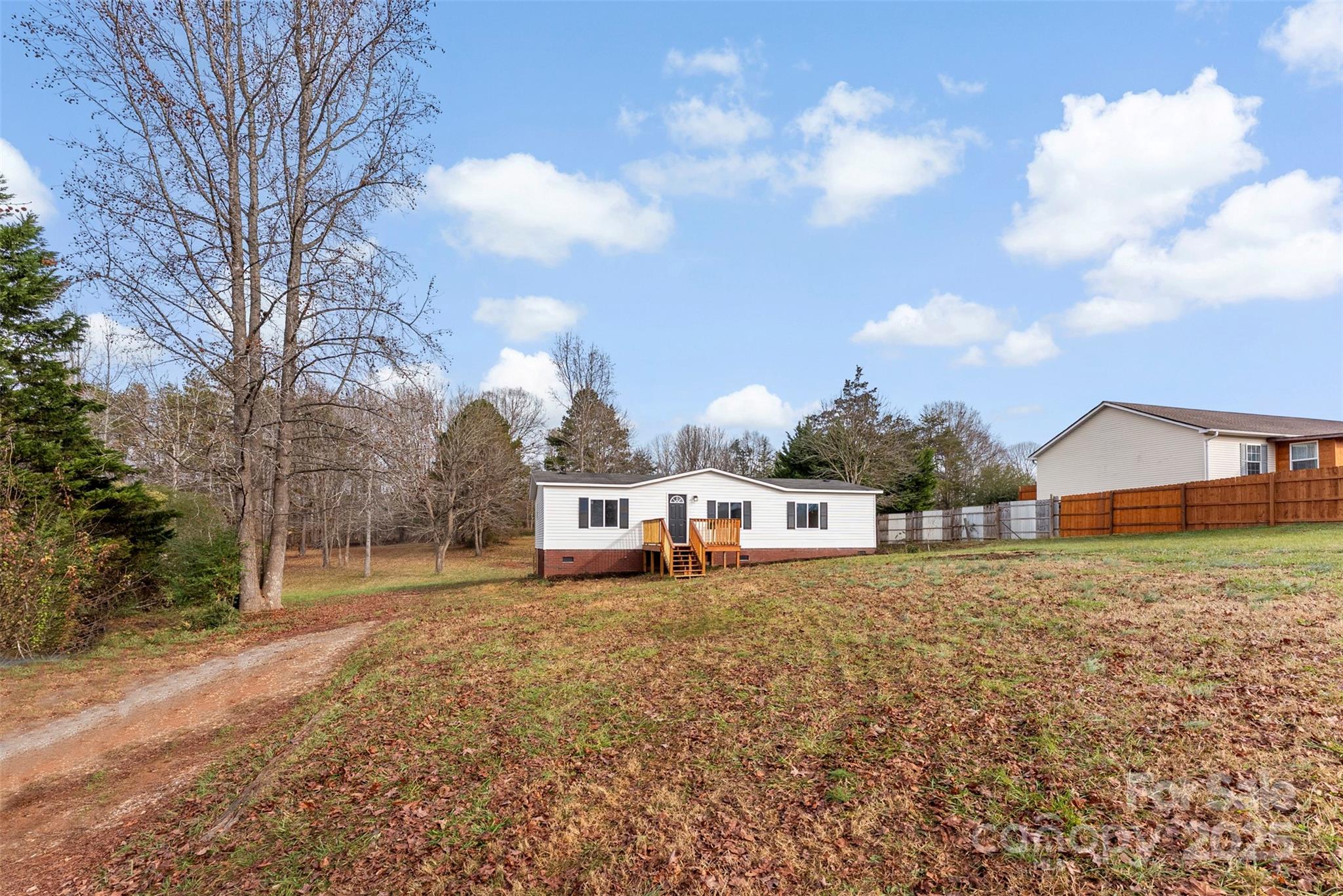 226 Muldoon Lane Clover, SC 29710 - Photo 4 of 31 a view of a house with a yard and fence