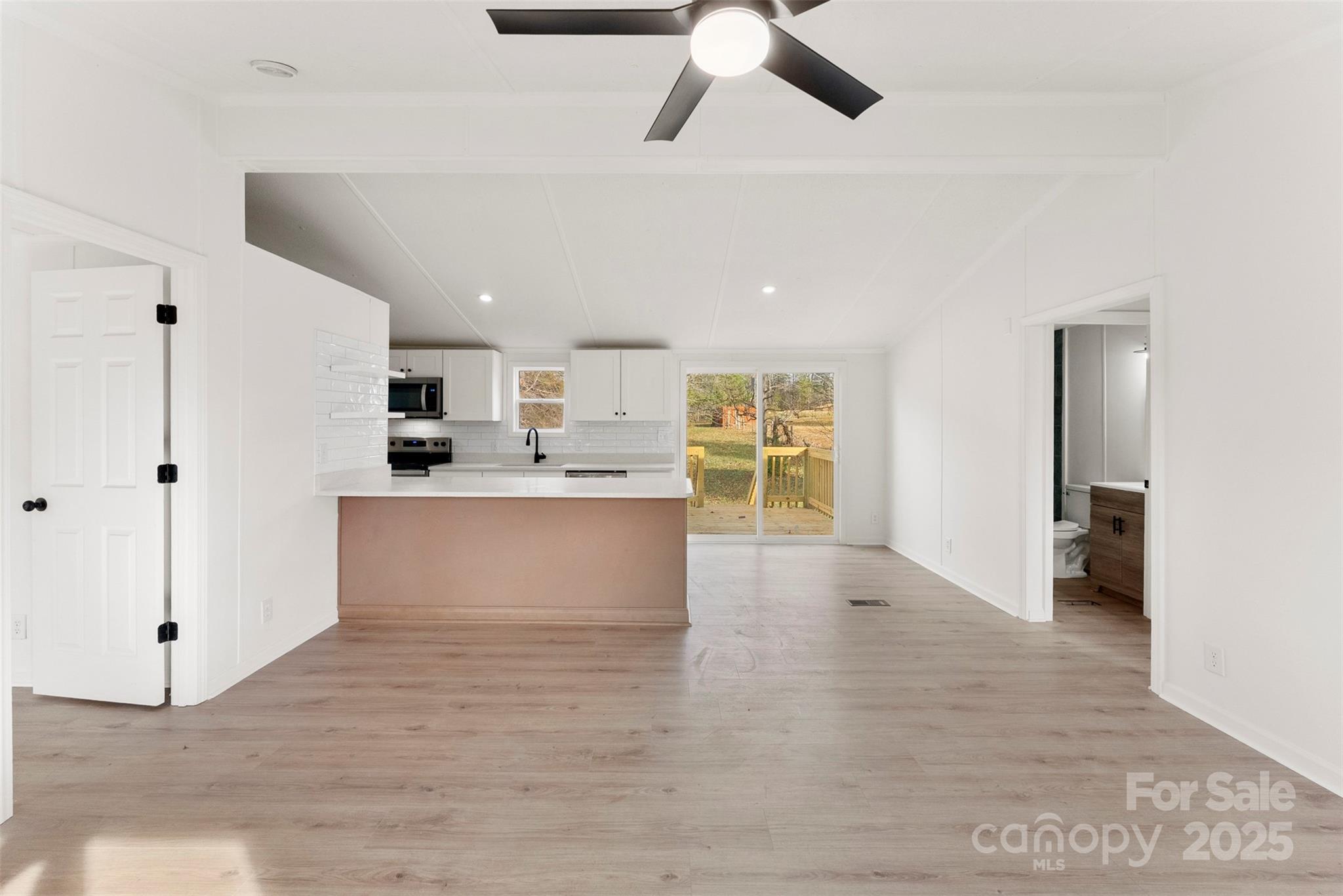 226 Muldoon Lane Clover, SC 29710 - Photo 7 of 31 a large kitchen with stainless steel appliances kitchen island a large counter top and a wooden floors
