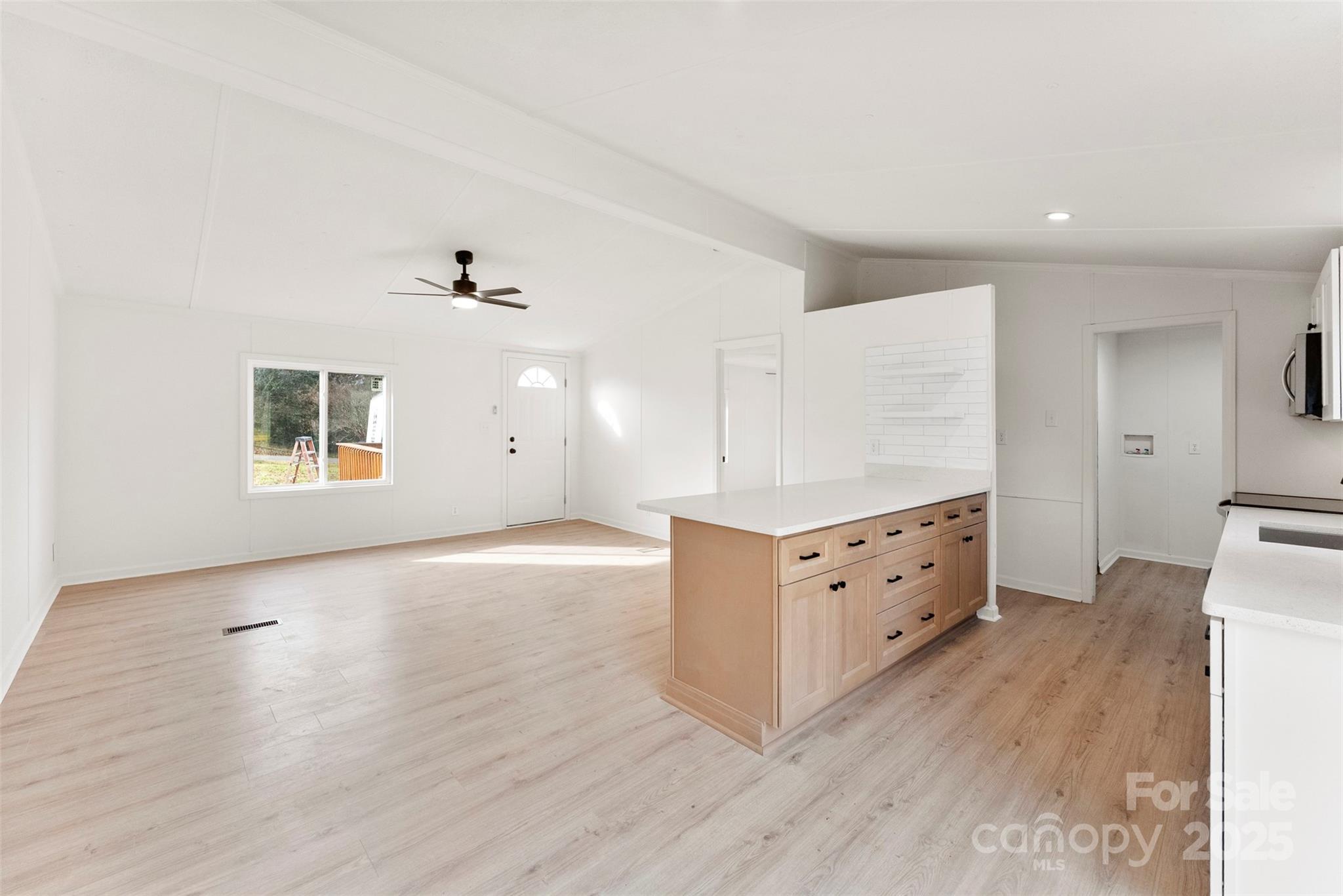 226 Muldoon Lane Clover, SC 29710 - Photo 8 of 31 an empty room with wooden floor and cabinet