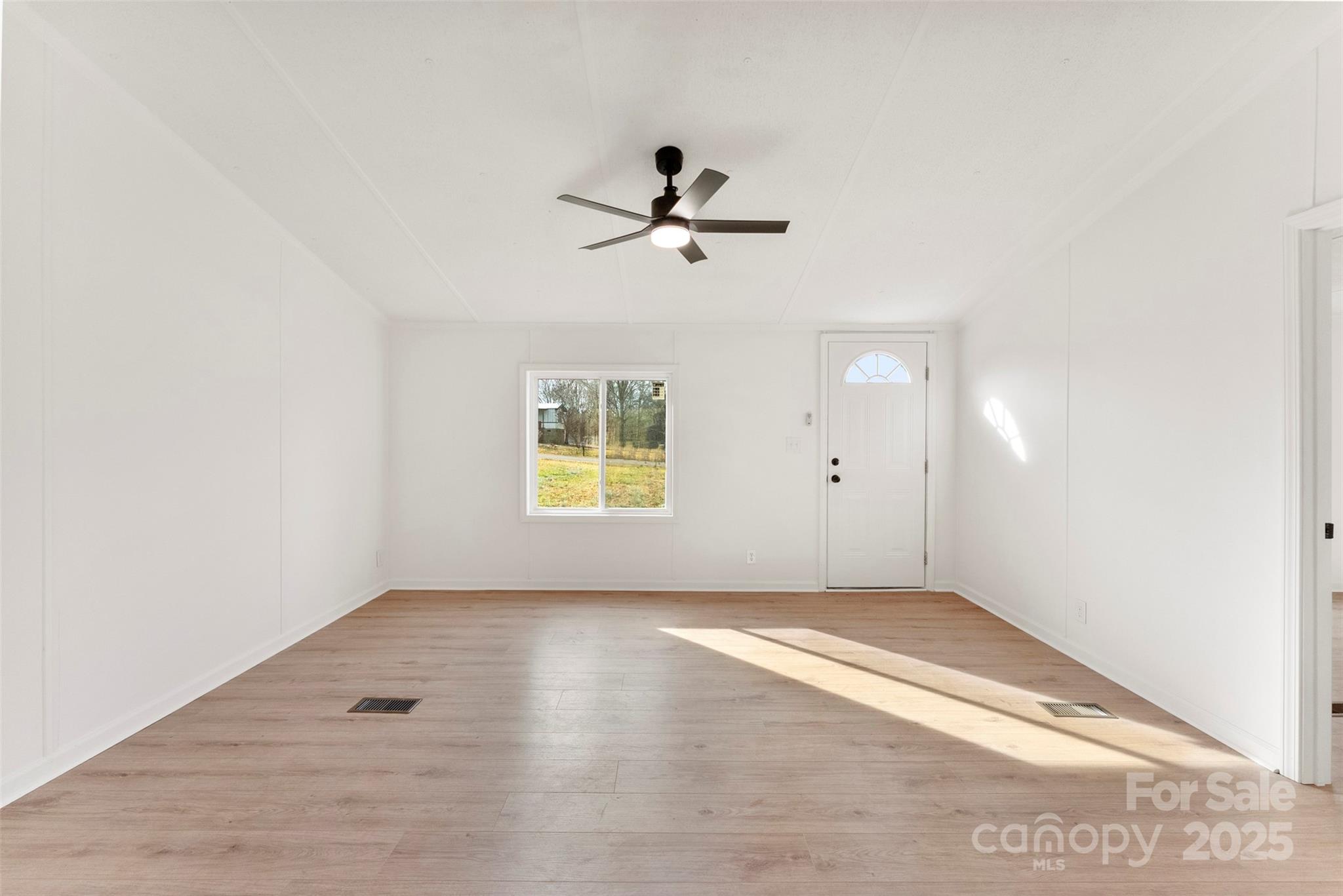 226 Muldoon Lane Clover, SC 29710 - Photo 9 of 31 an empty room with a window and ceiling fan