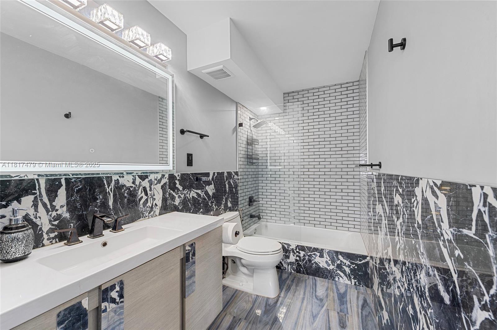 1345 Lincoln Road, Unit 1105 Miami Beach, FL 33139 - Photo 12 of 25 a bathroom with a sink a toilet and shower