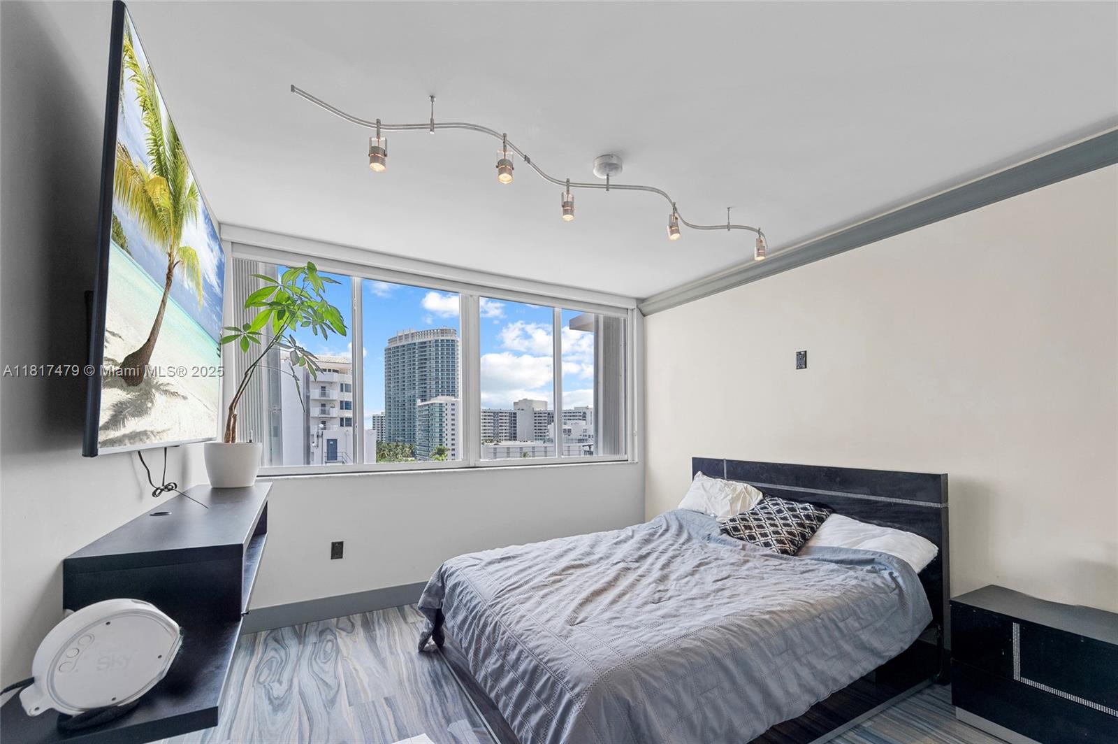 1345 Lincoln Road, Unit 1105 Miami Beach, FL 33139 - Photo 13 of 25 a bedroom with a bed dresser and a window