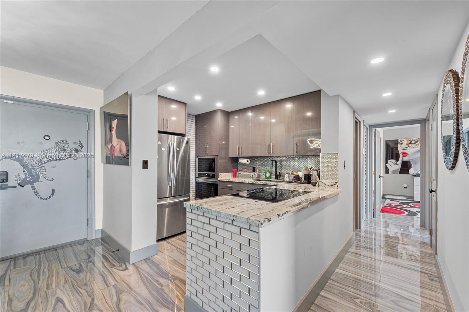 1345 Lincoln Road, Unit 1105 Miami Beach, FL 33139 - Photo 3 of 25 a kitchen with stainless steel appliances granite countertop a refrigerator and a sink