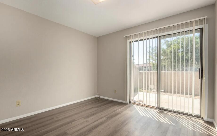 2040 South Longmore, Unit 66 Mesa, AZ 85202 - Photo 11 of 25 a view of an empty room with wooden floor and a window