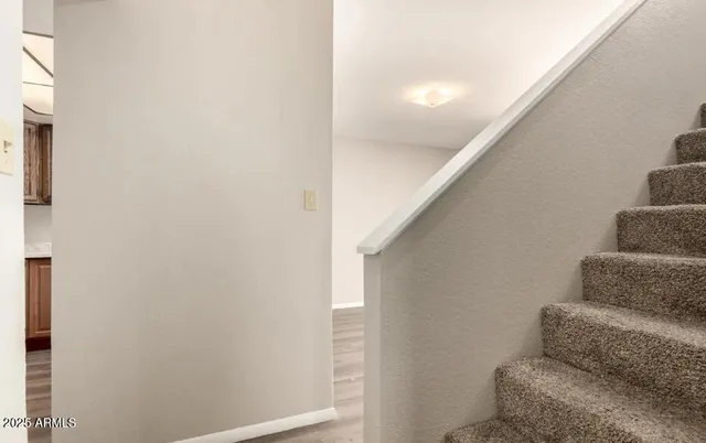 a living room with furniture and a hallway