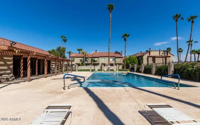 a view of a swimming pool with a lounge chair